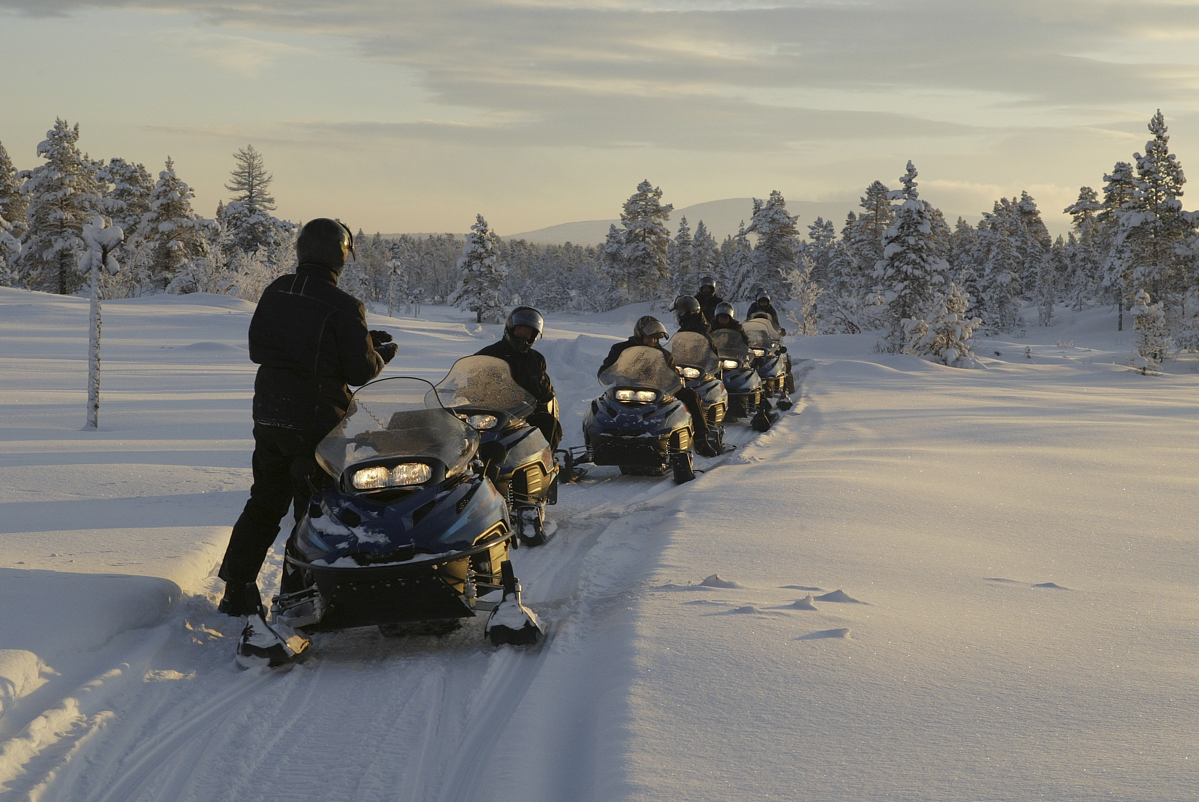 Snowmobile safari through Finland&rsquo;s snowy landscape, a must-do adventure on Inspiring Vacations Finland tours