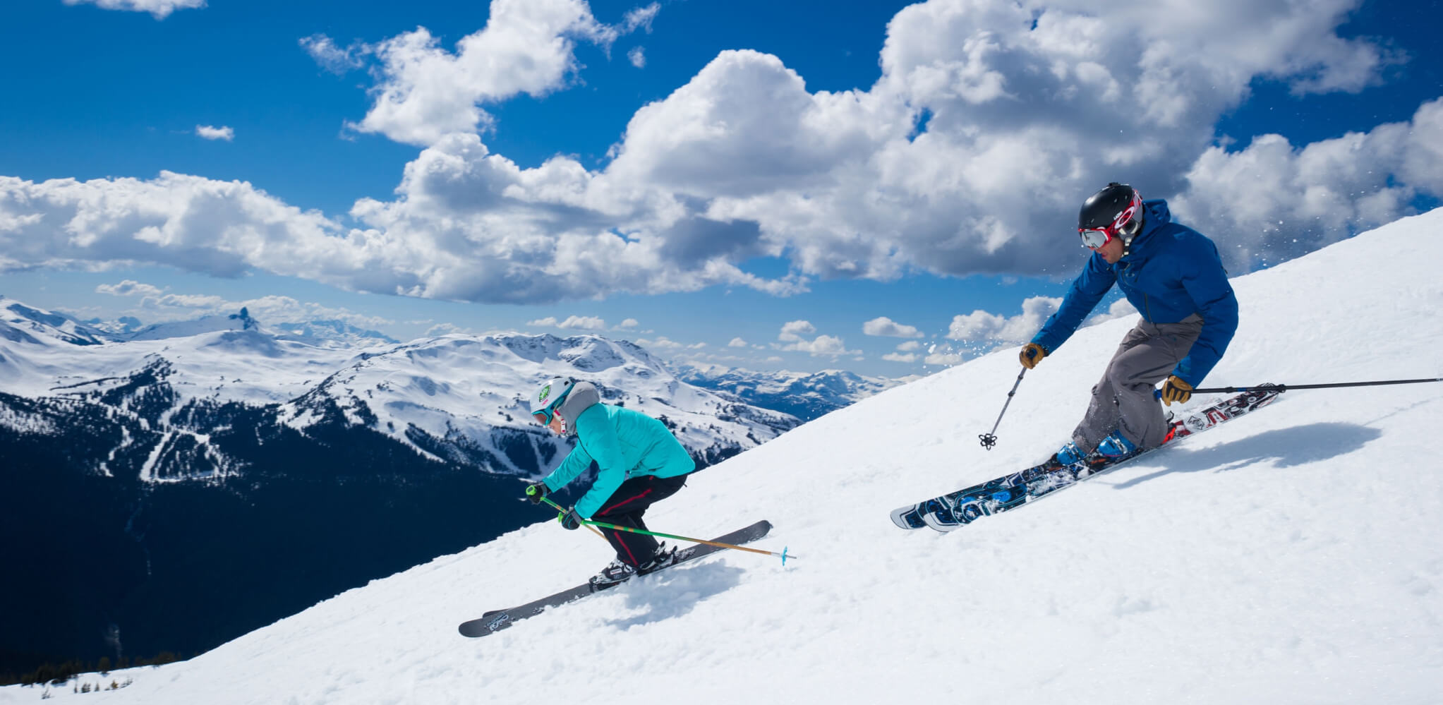 Two skiers descend from the Blackcomb Mountains, enjoying the crisp, powdery snow