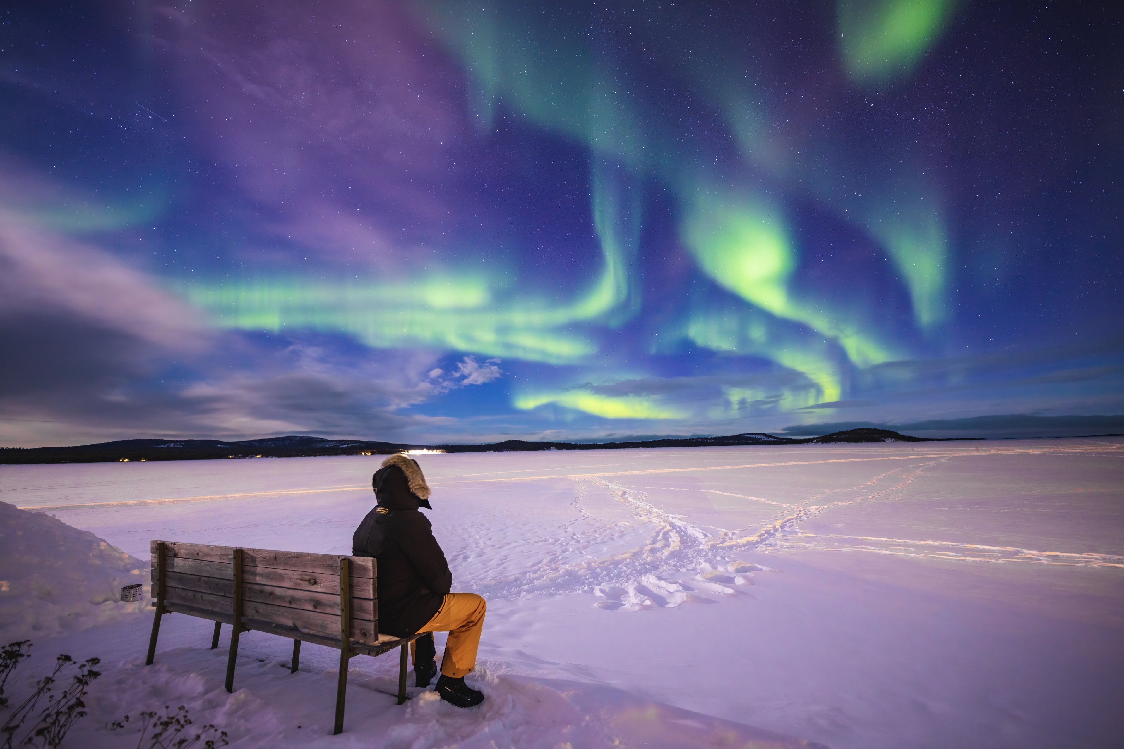 The Aurora Borealis lights up the night sky in Finnish Lapland, an awe-inspiring tourism experience in Finland.