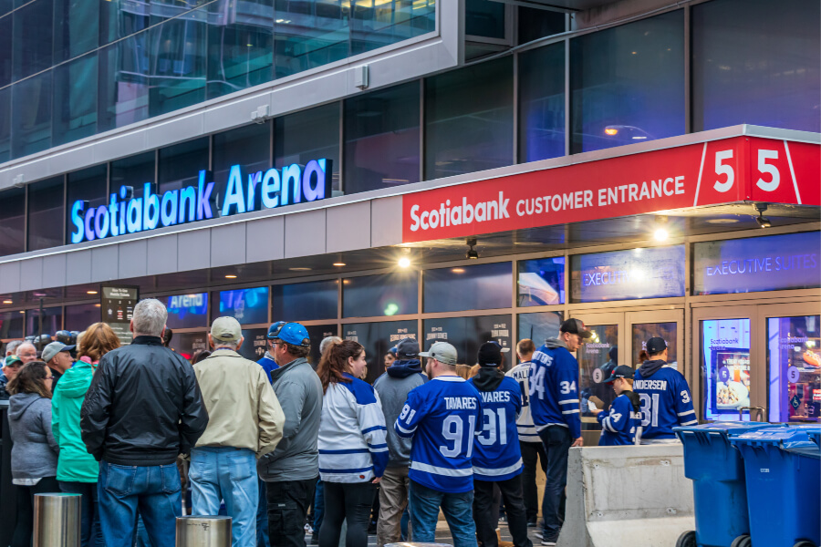 Toronto Maple Leafs fans eagerly await entry to the Scotiabank Arena for a NHL hockey game in the heart of Toronto