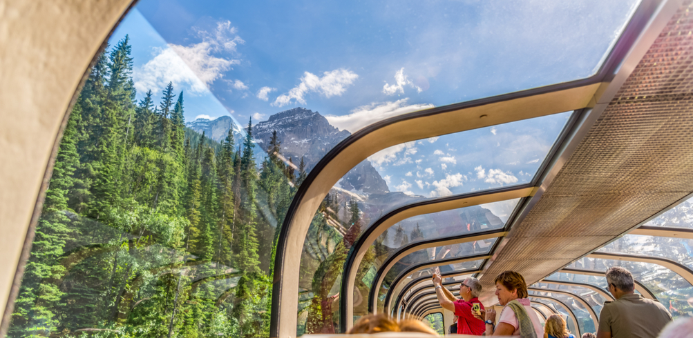 Passengers aboard the Rocky Mountaineer enjoying panoramic views