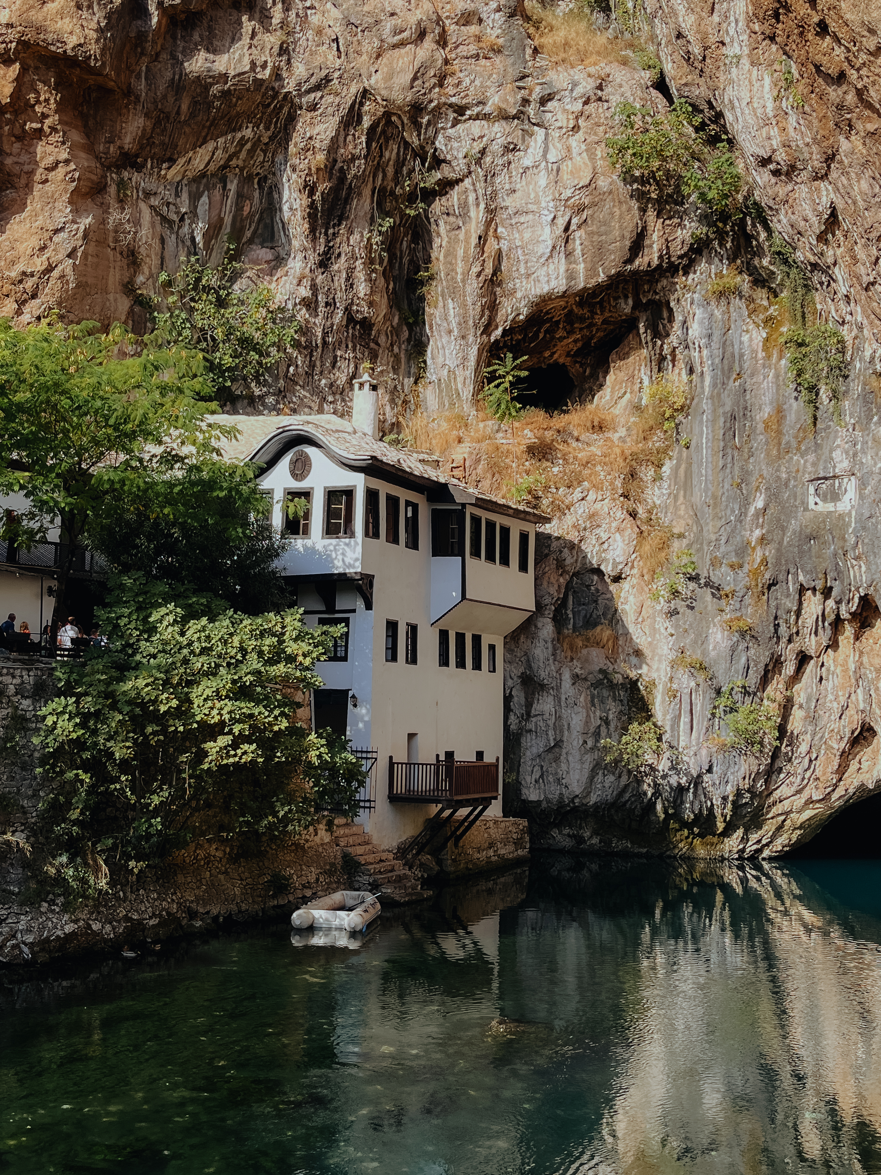 Blagaj Tekija Dervish monastery built into a cliffside near turquoise water in Bosnia