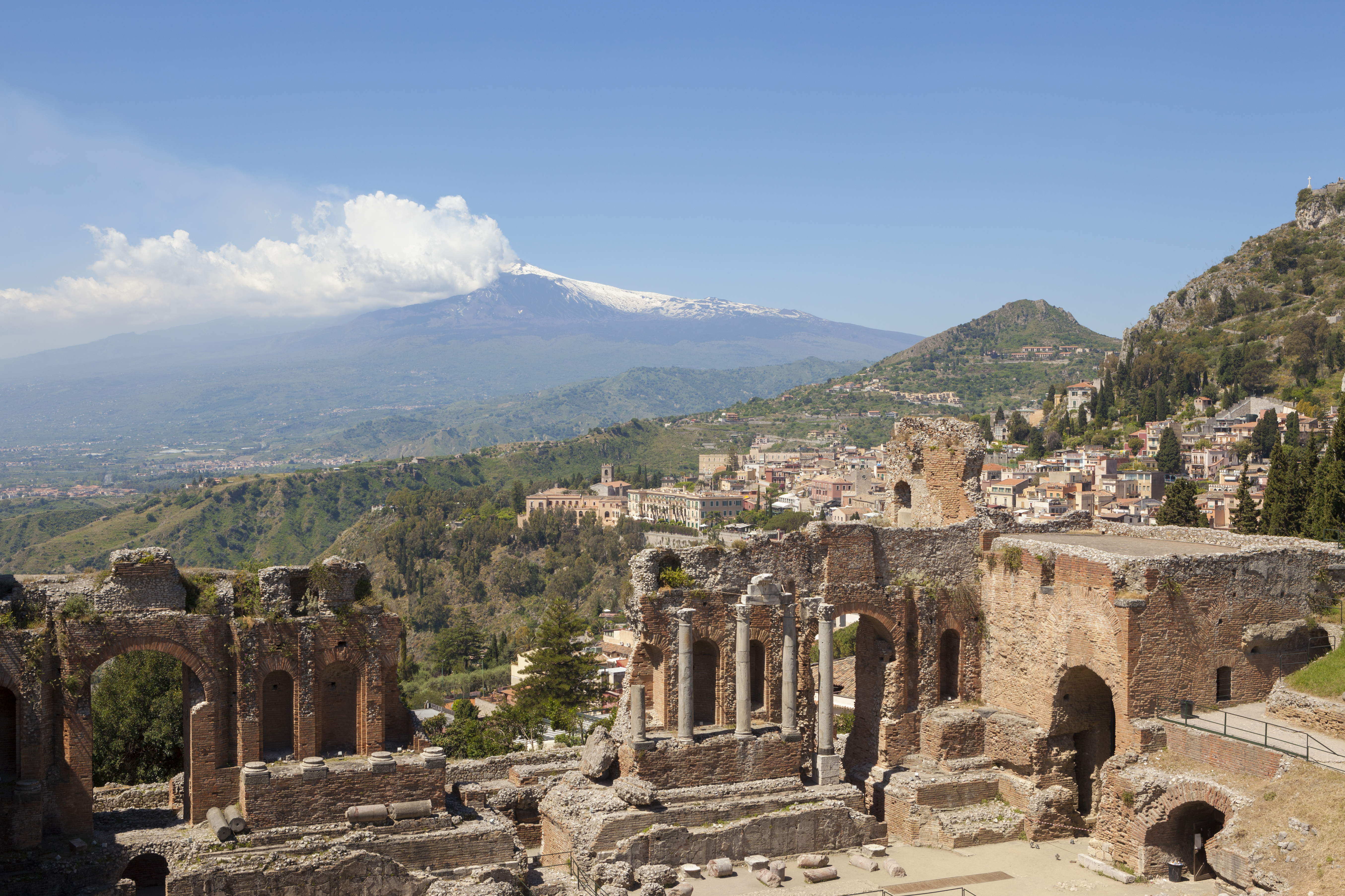 The Ancient Greek Theatre of Taormina, with sweeping views across the coastline to Mount Etna in the distance