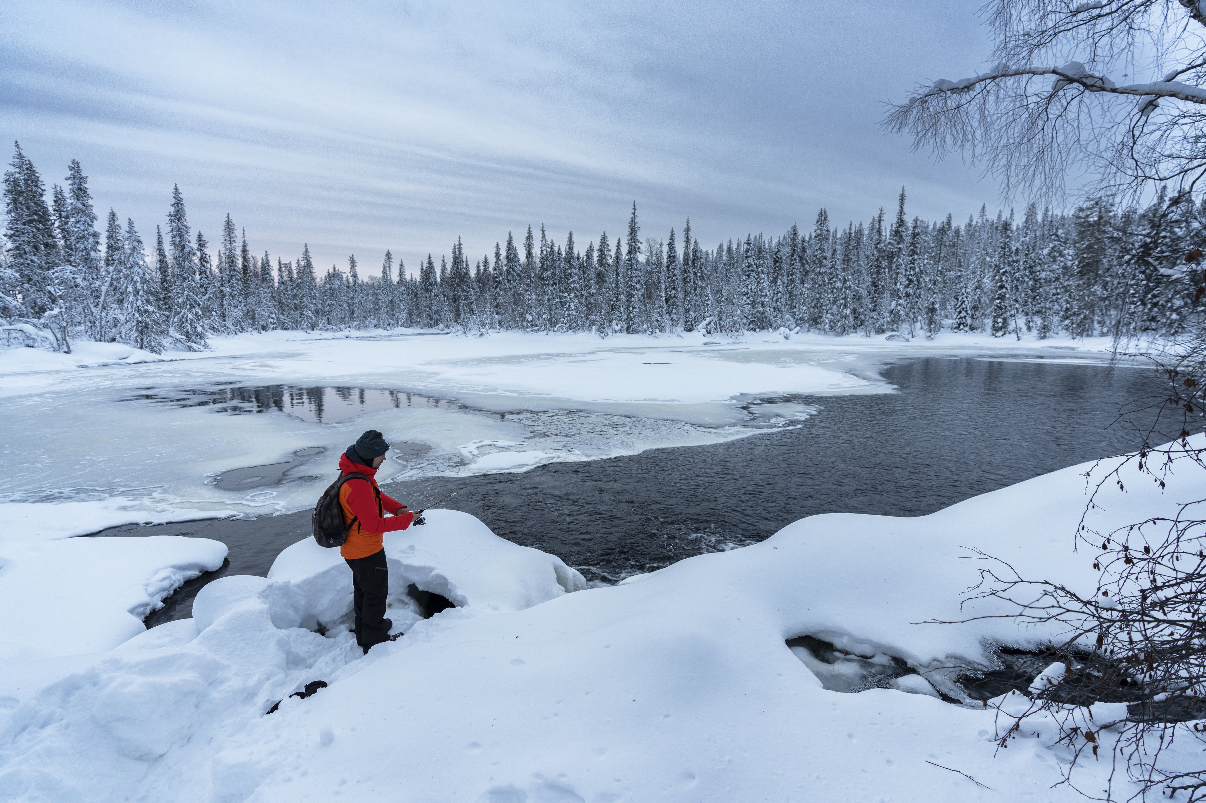 Ice fishing on a frozen lake in Finland is a peaceful winter pastime and a highlight of Finnish tourism.&nbsp;