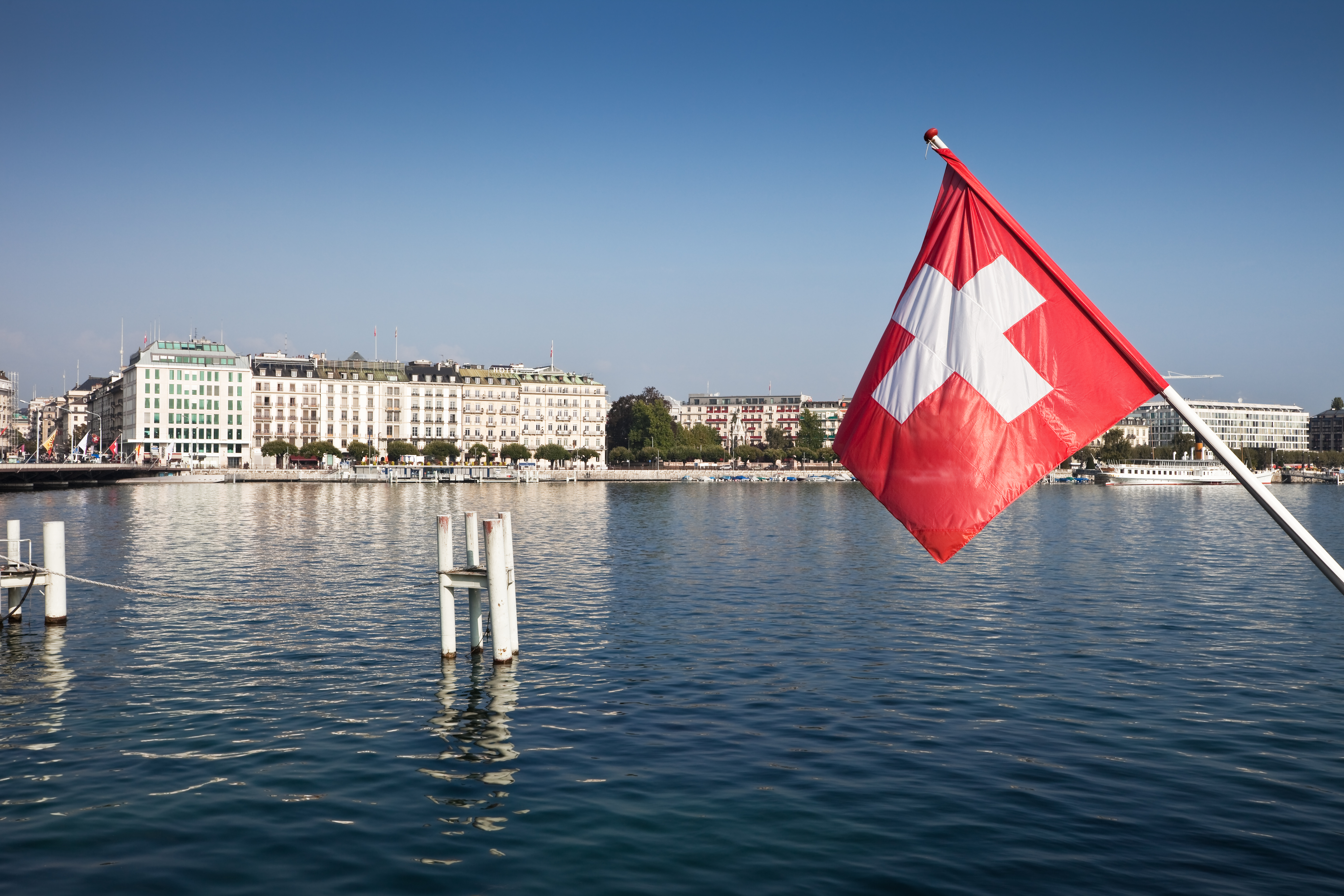 Iconic Lake Geneva view with the Swiss flag fluttering in the breeze