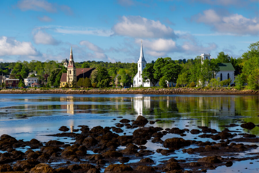 The iconic trio of historic churches lining the waterfront in Mahone Bay, one of the most quaint villages in Nova Scotia