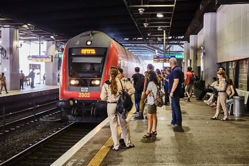 Tourists and locals await the arriving train at a Tel Aviv station