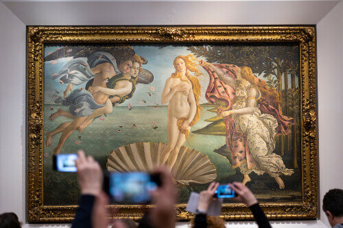 Visitors take photos of the Birth of Venus by Botticelli in the Uffizi Gallery.