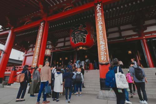 Visitors wait to enter the Sensoji Temple, Tokyo.