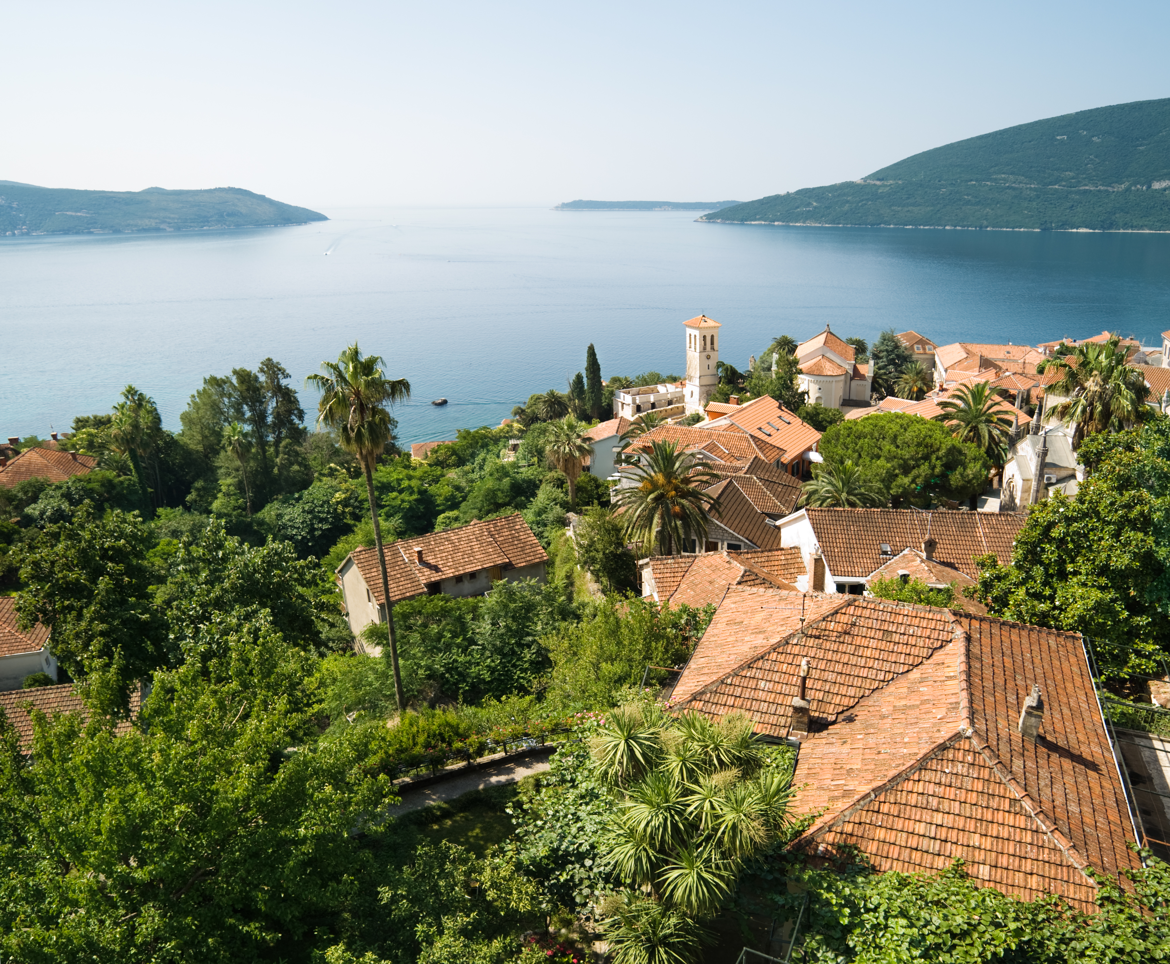 View of Herceg Novi in Montenegro with terracotta rooftops and the Adriatic Sea.
