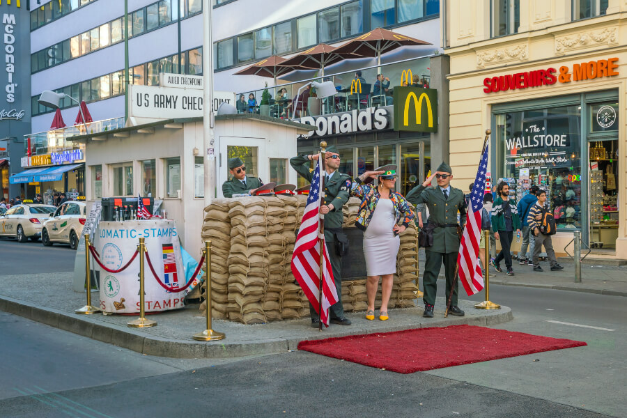 Two soldiers posing for a tourist at Checkpoint Charlie.