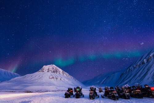 The arctic Northern Lights sky is visible in Svalbard