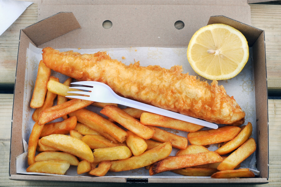 Tasty fish and chips on a table.