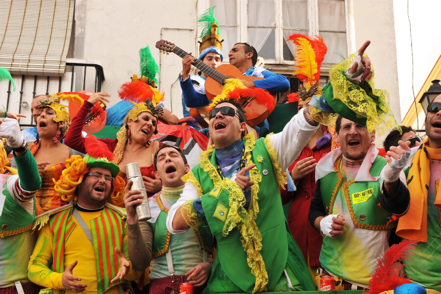 Chirigota performers sing in the streets during Cadiz Carnaval in Spain