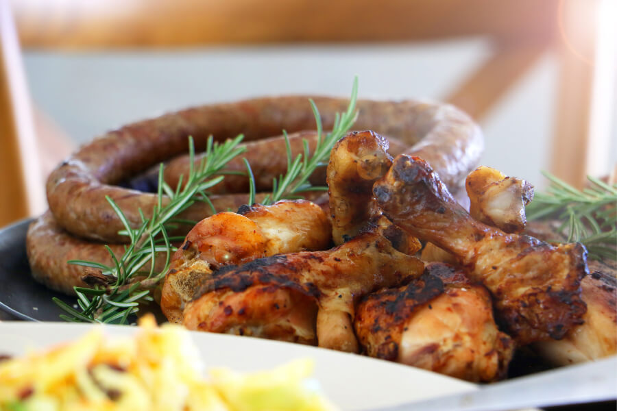 Peri-peri chicken and boerewors served together, two must-try South African dishes