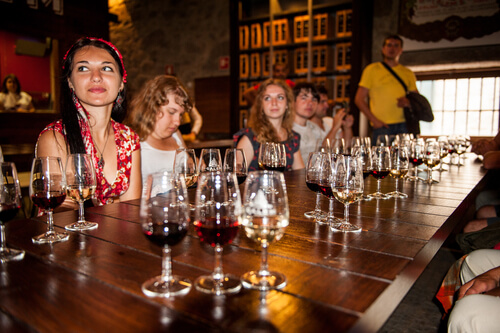 Visitors enjoy port wine tasting in Porto Portugal.