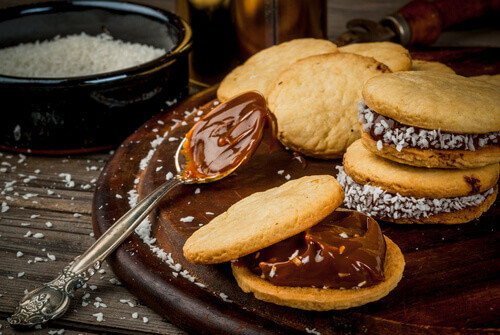 Traditional dessert shortbread cookies served with dulce de leche and coconut in Argentina.
