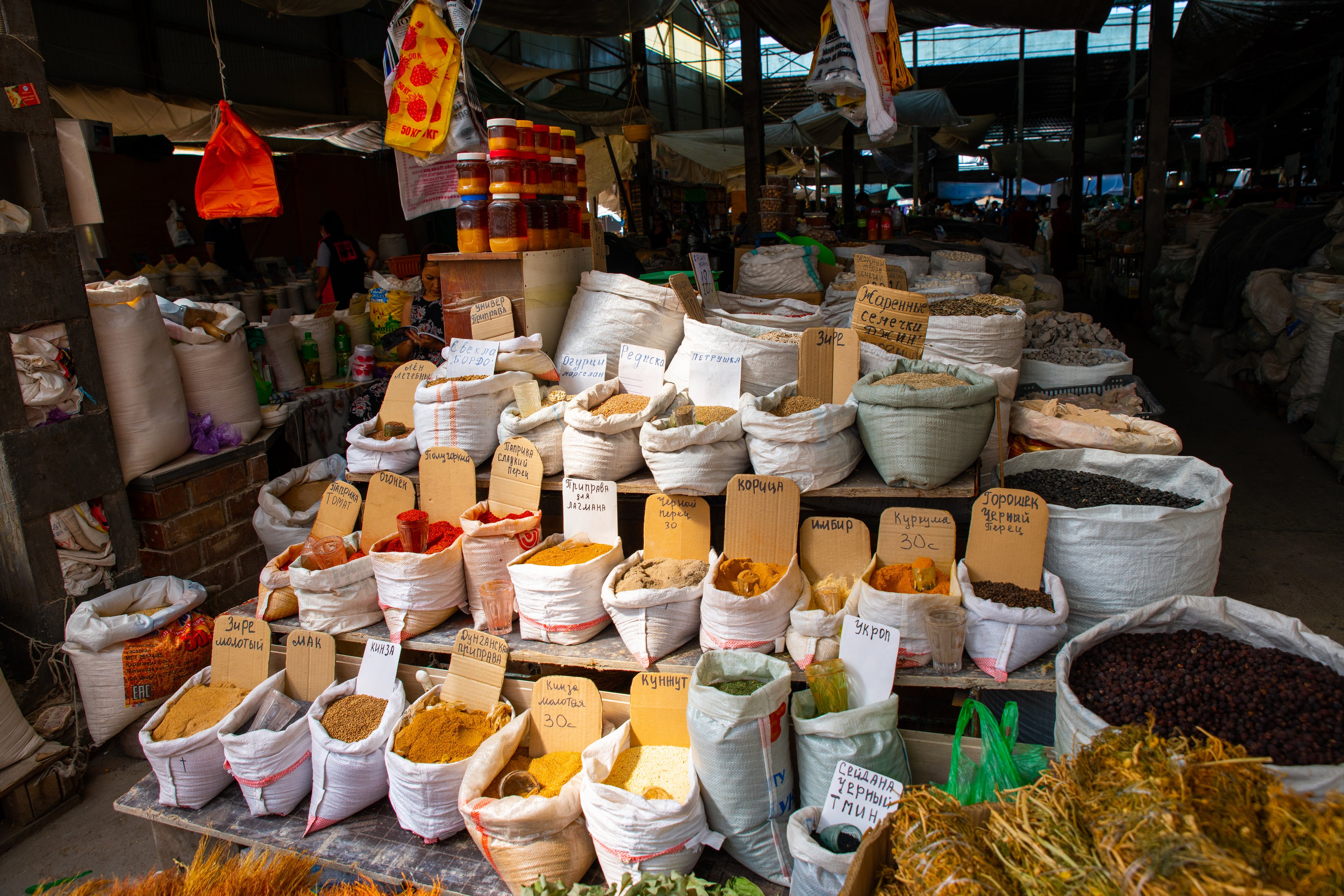 Colourful stalls at Osh Bazaar in Bishkek selling fresh food and local snacks.