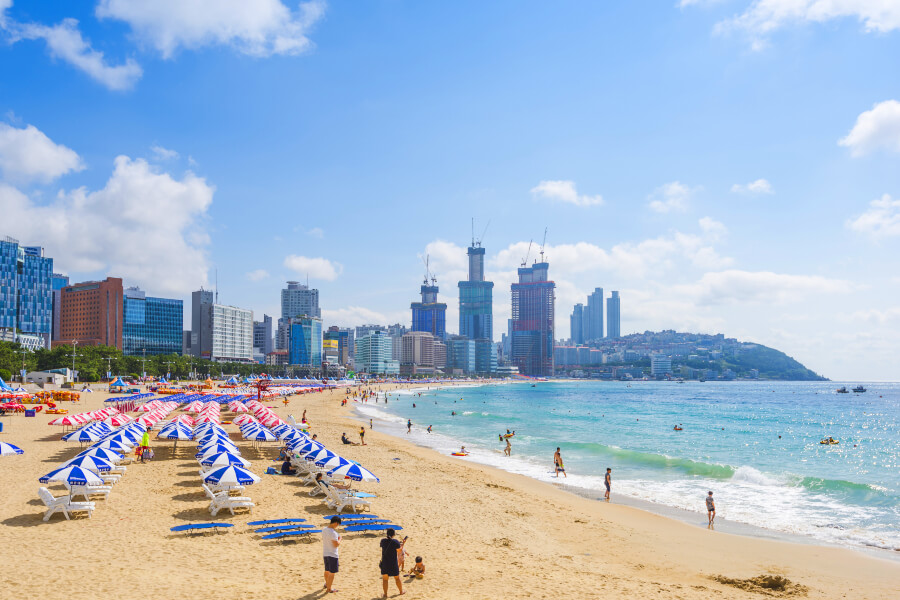 Visitors enjoy the sun and sea at Haeundae Beach, Busan, during summer