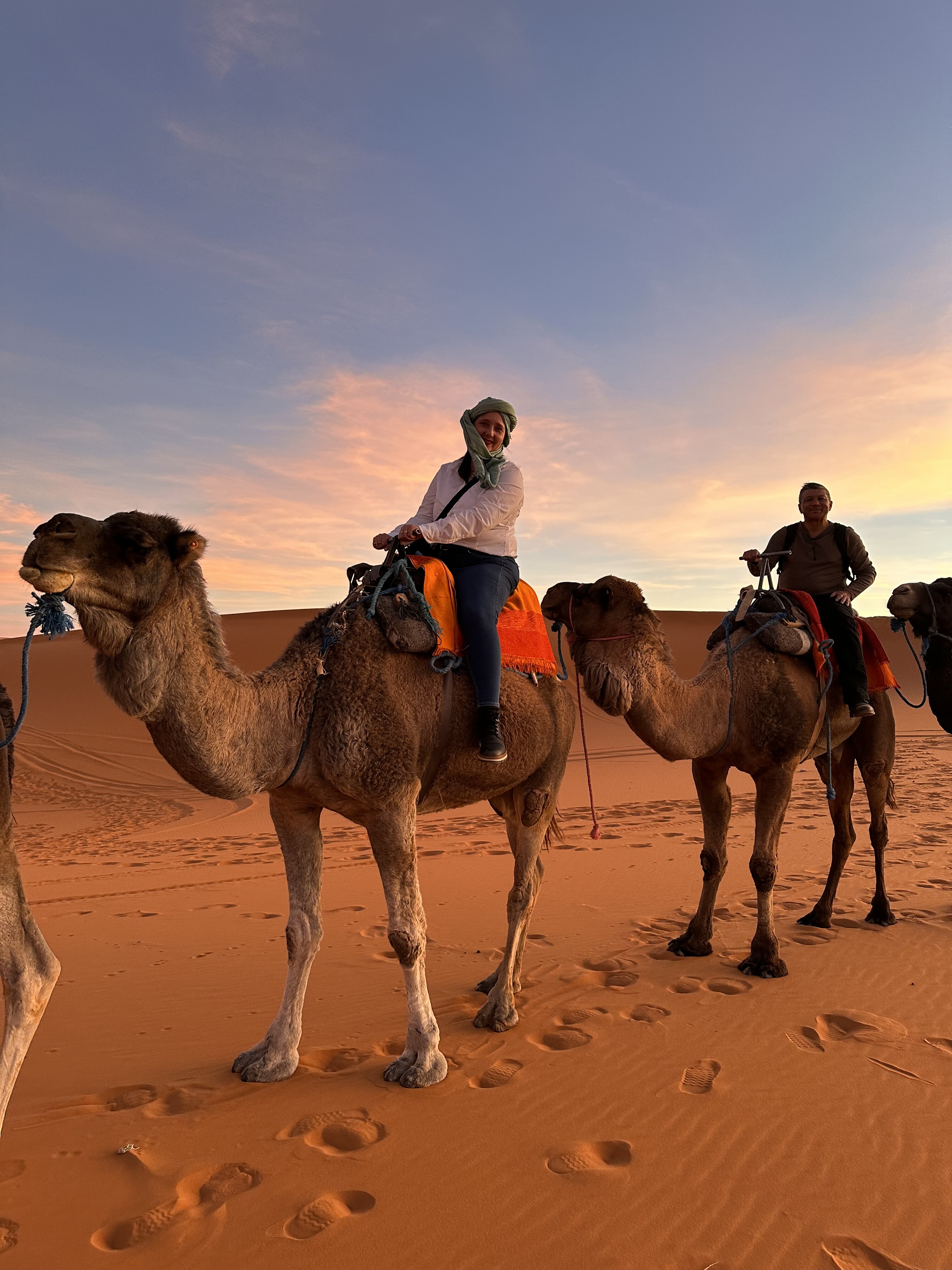 Inspiring Vacations customer Liz enjoys a camel ride in the Sahara Desert during one of our exciting Spain, Portugal, and Morocco tours (Photo: supplied)