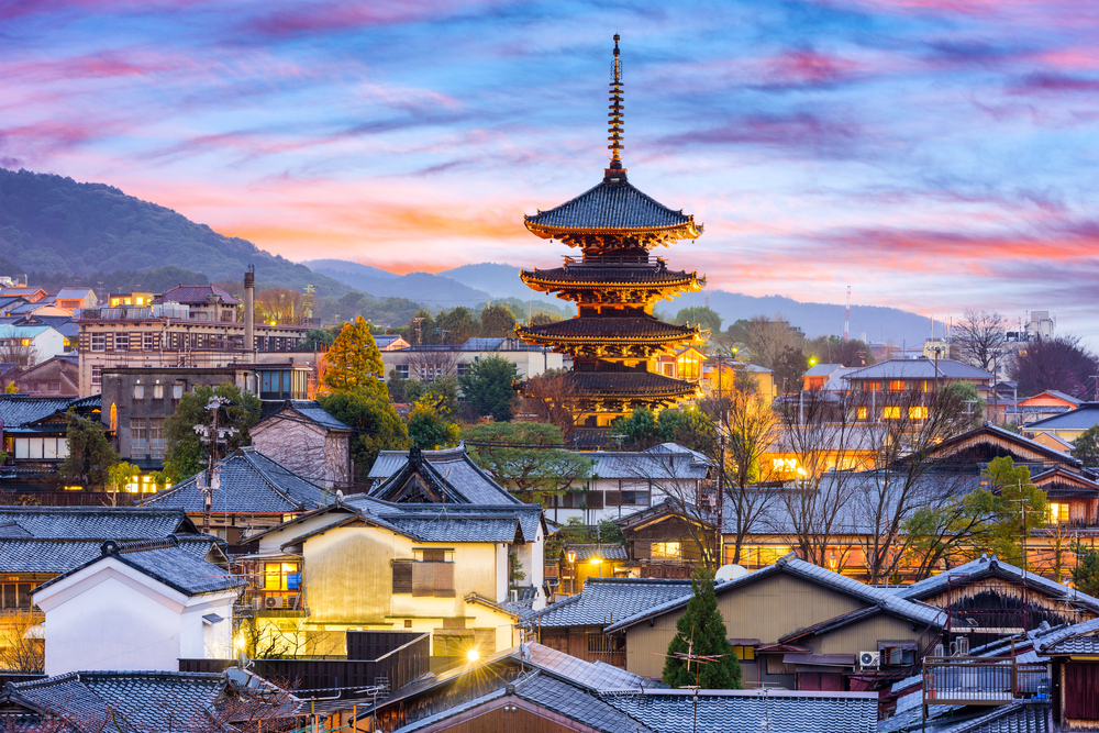 Historic streets of Higashiyama in Kyoto at dusk, lined with traditional tea rooms and wooden buildings.