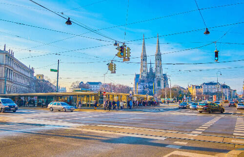 The intersection of Schottengasse and Ringstrasse with a view on Gothic Votive Church in Vienna.