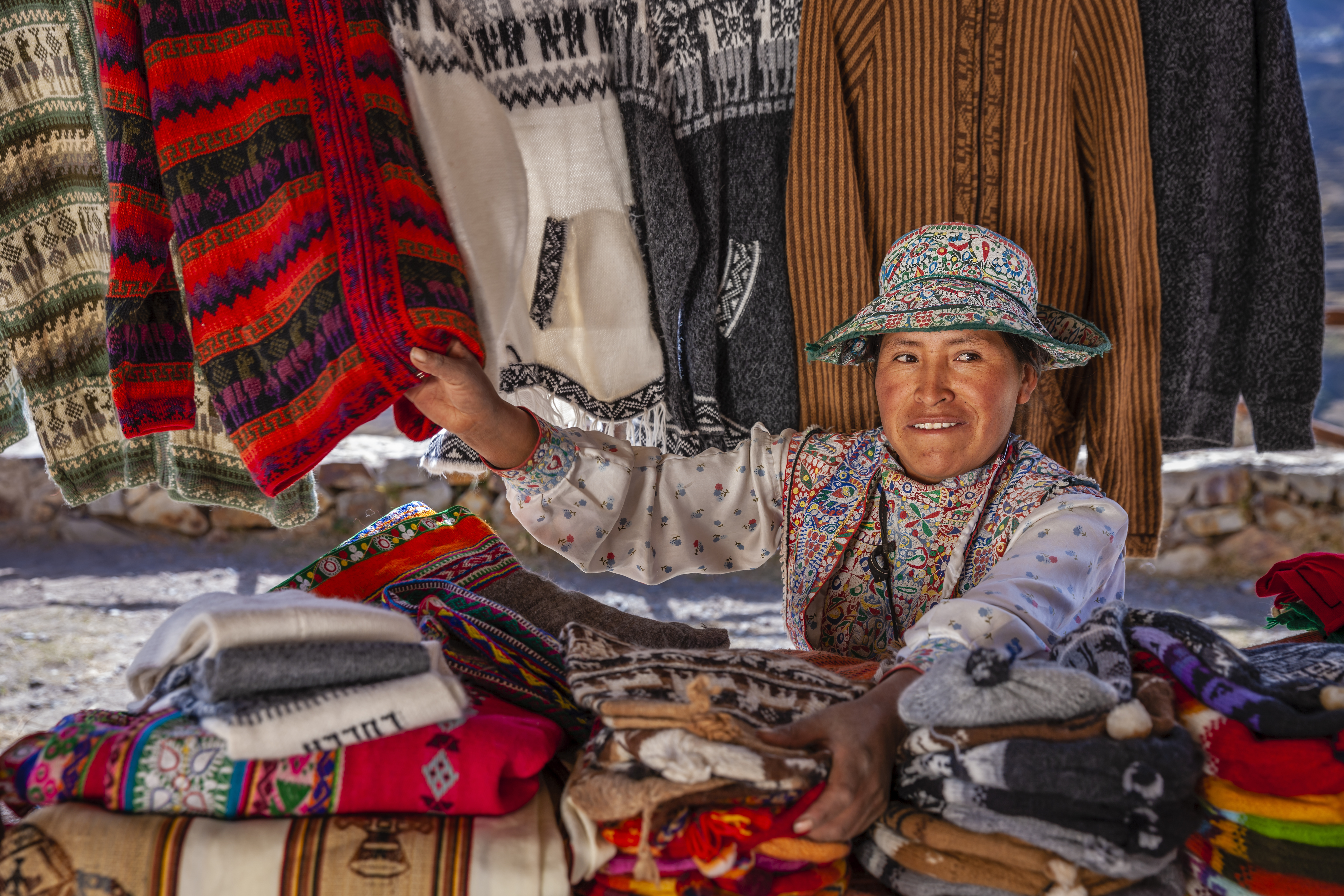 Peruvian woman selling souvenirs in her shop near Colca Canyon, Peru.