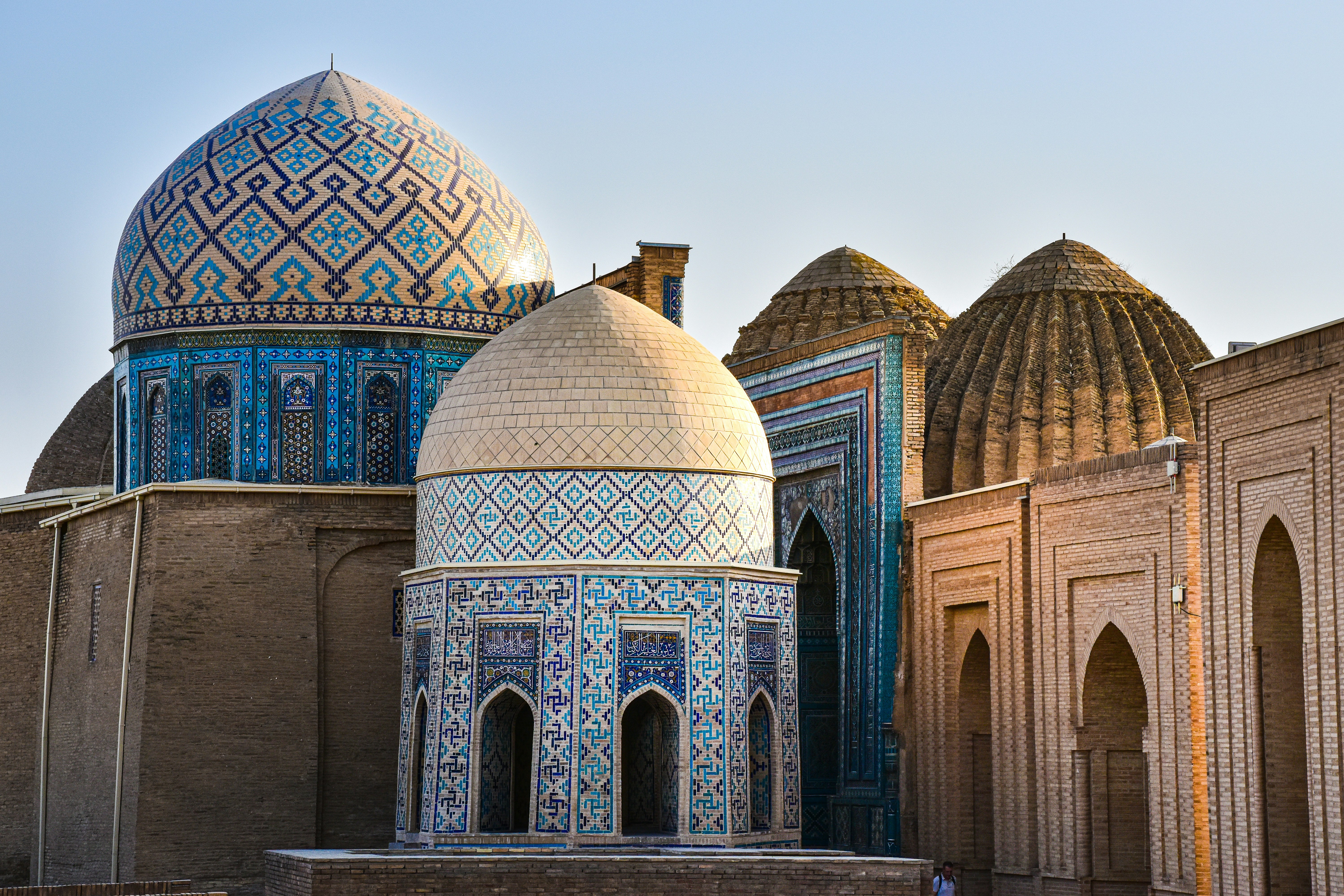 Intricate domes and tiled facades of a mosque in Samarkand, an essential Uzbekistan cultural site