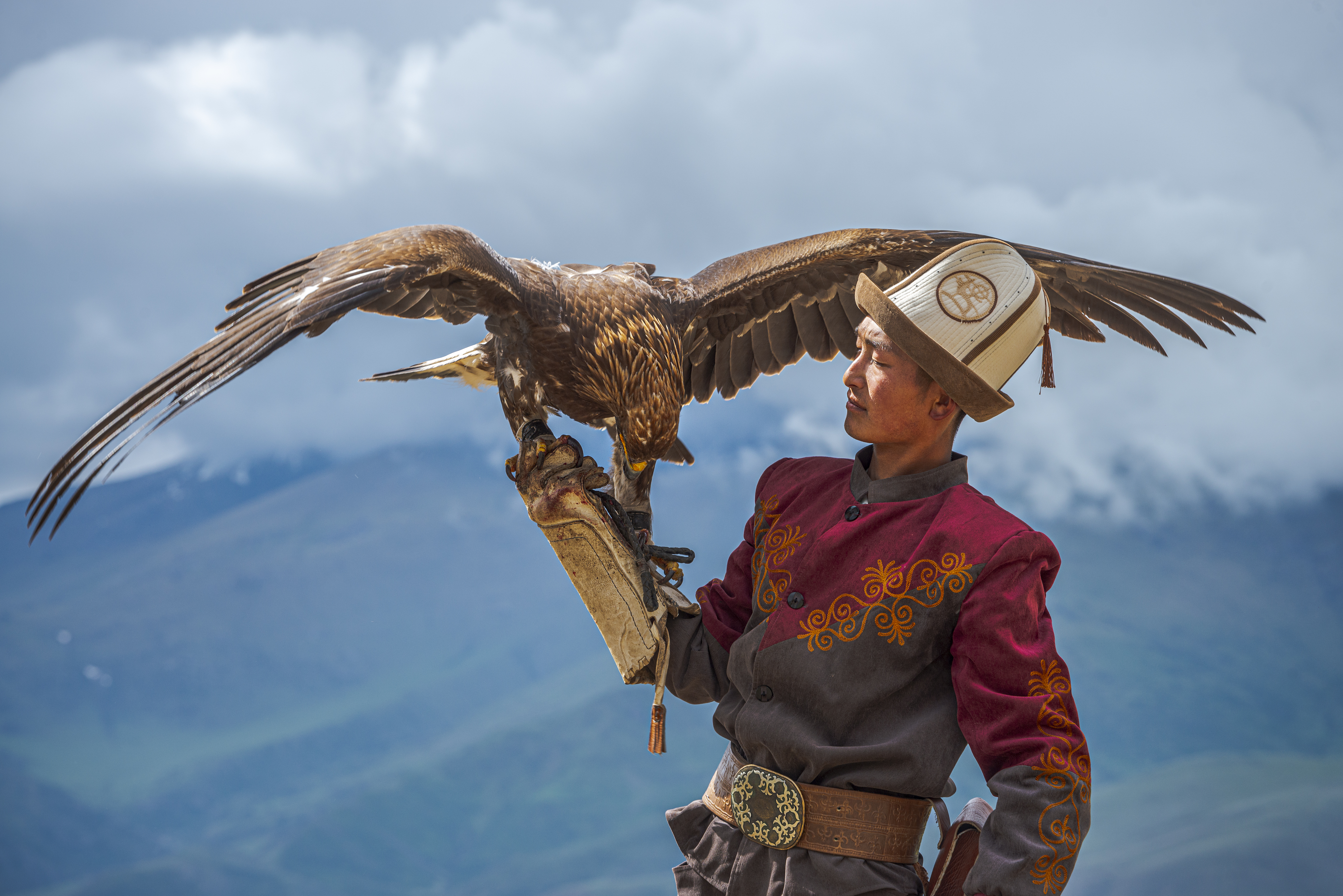 A Kyrgyz hunter showcasing the bond with his golden eagle