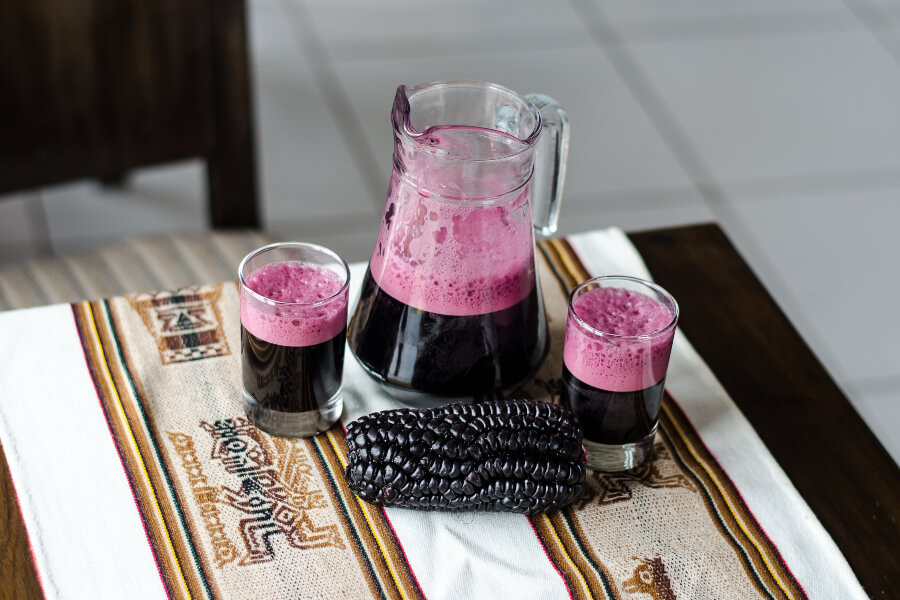 A glass of chicha morada, a traditional purple corn juice enjoyed during the Inti Raymi festival