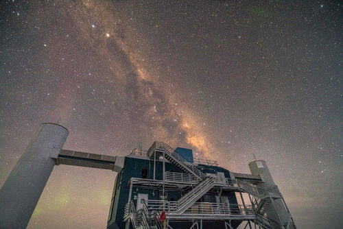 The IceCube Neutrino Observatory under the Milky Way skies in Antarctica.