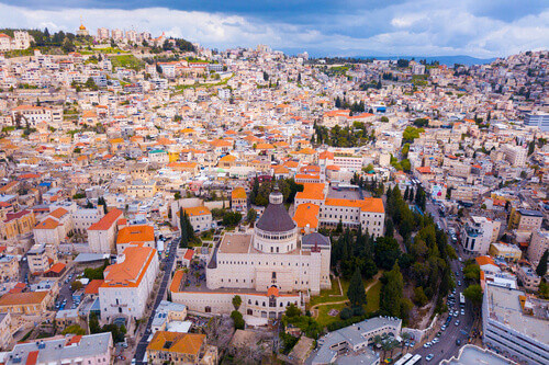 Aerial footage of the Basilica of the Annunciation over the old city houses of Nazareth, Israel.
