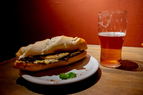 A Bondiola pork sandwich accompanied by a craft beer in Argentina.
