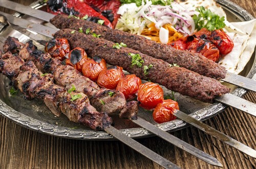 The traditional Kubideh Kebab laid out on a table.