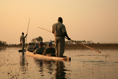 In Botswana, visitors and locals can see the natural sights via canoe.