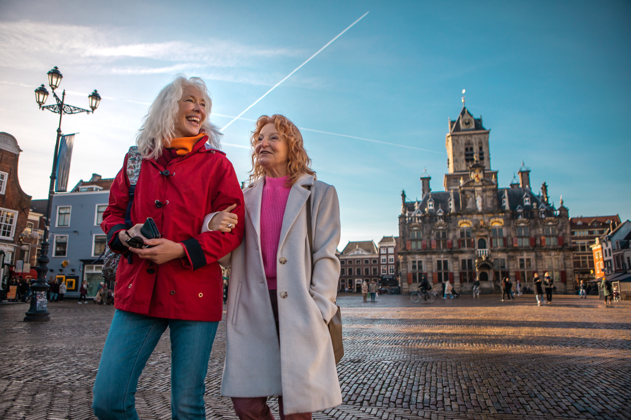 Two travellers enjoying a stroll through a charming city square
