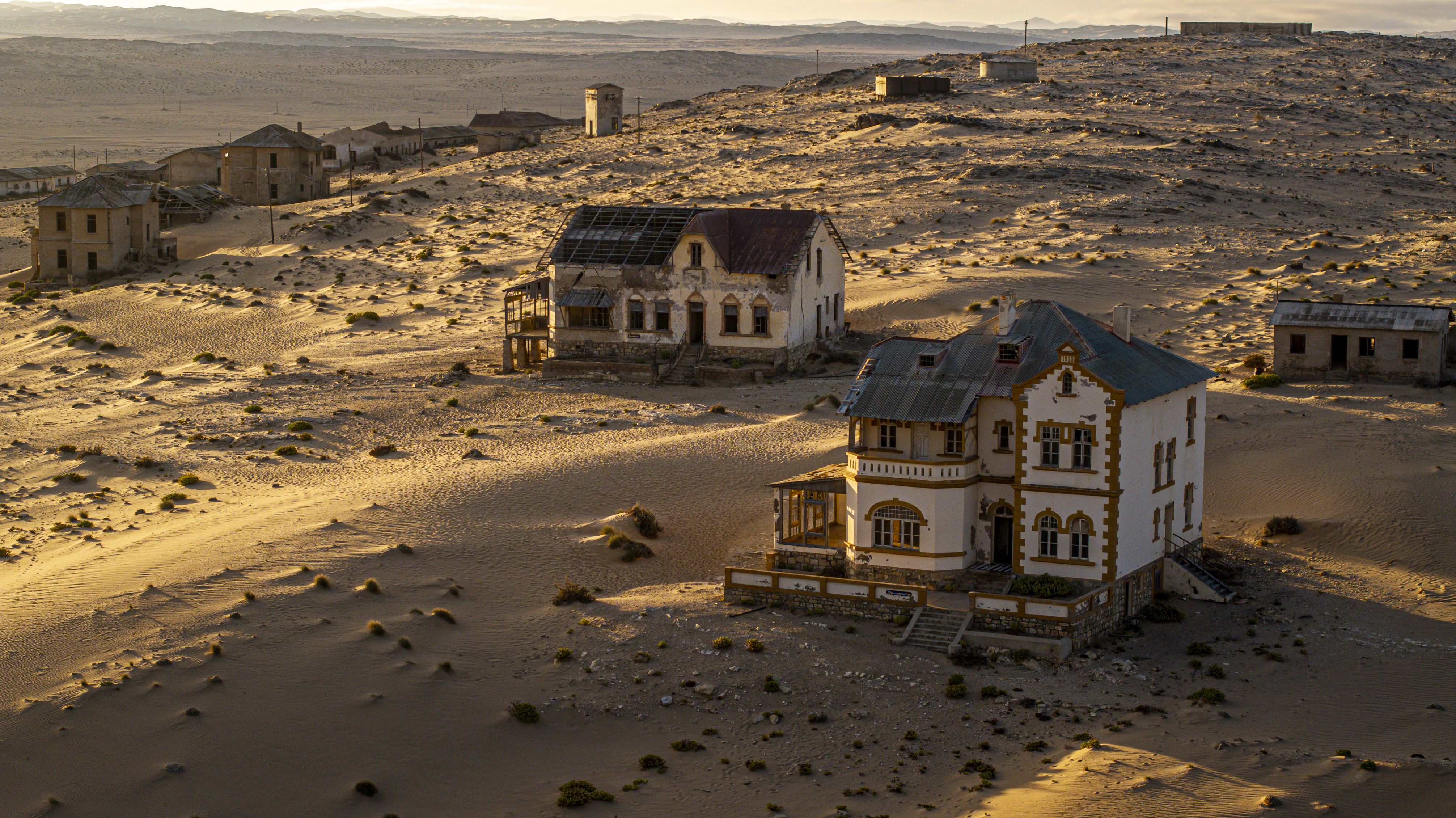 Kolmanskop ghost town in Namibia, where historic homes are slowly being reclaimed by the encroaching Namib Desert sands.