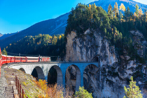 A train travelling on the famous Landwasser Viaduct into the tunnel of Canton of Grisons in Switzerland.