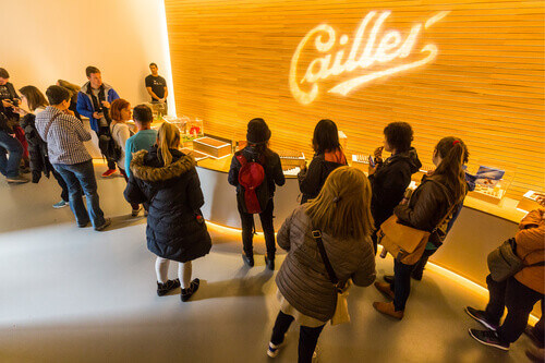 People trying chocolate at the Cailler factory tour in Broc, Switzerland.