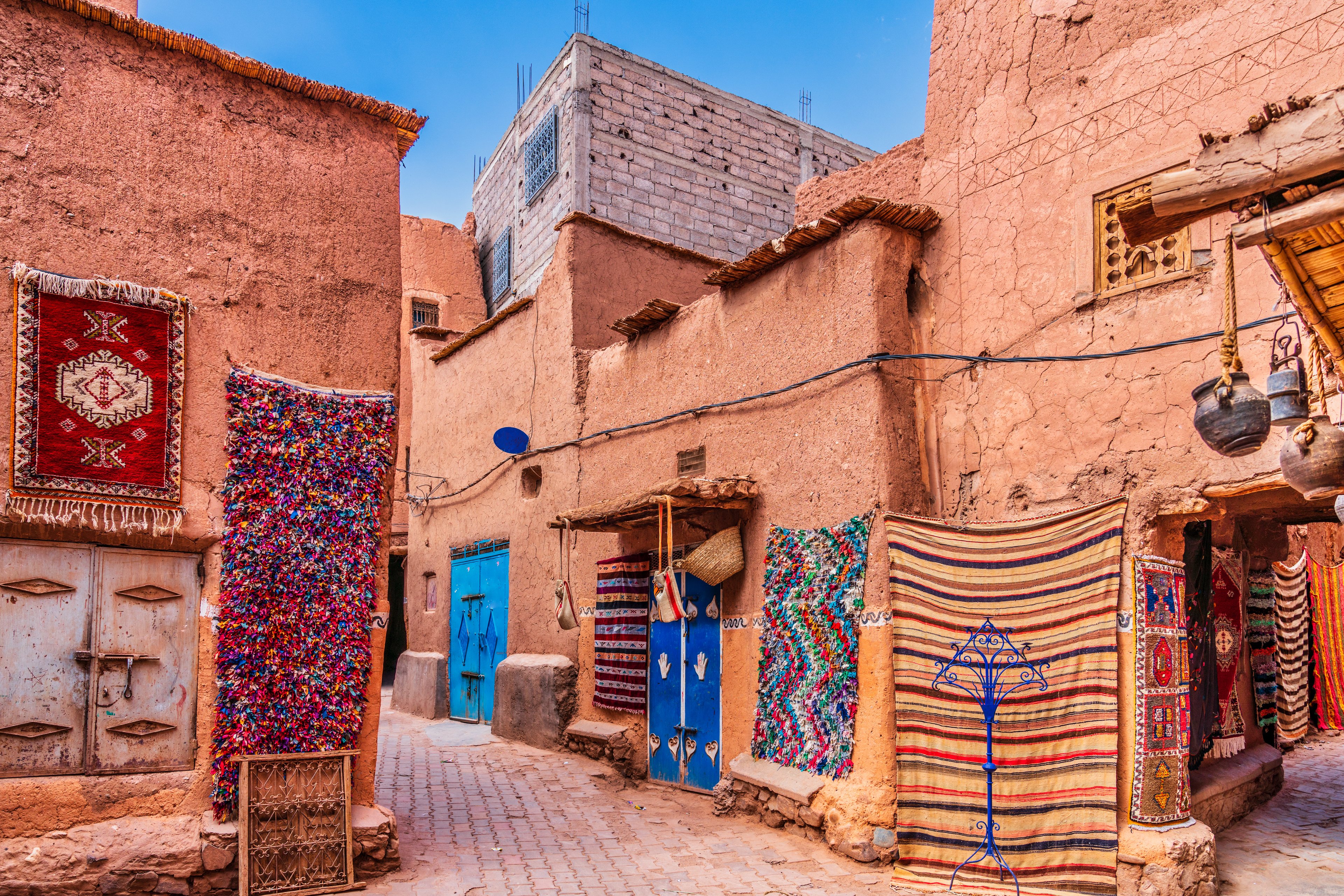Handmade carpets and rugs displayed at a Moroccan market, reflecting local culture and craft.
