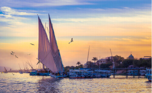 Felucca sailing on the Nile during sunset in Egypt.