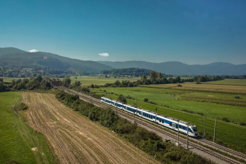 A train travels through the Italian countryside.
