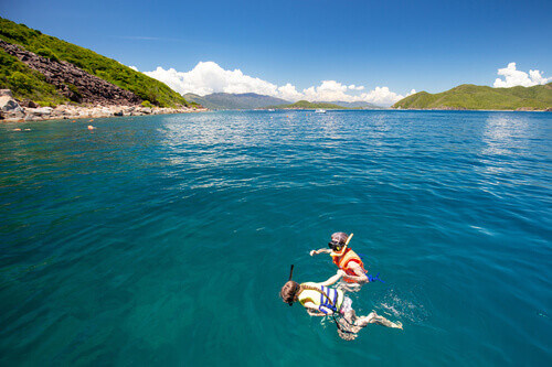 Two people snorkel off the island of Hon Mun near Nha Trang in Vietnam