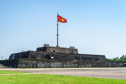 Wonderful view of the flag of Vietnam fluttering over a tower in the Citadel in Hue, Vietnam.