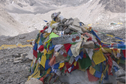 Prayer flags and a sign at the Everest Base Camp.
