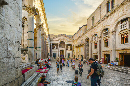 Tourists and locals enjoy an afternoon in the Roman Peristil Square in Docletians Palace.