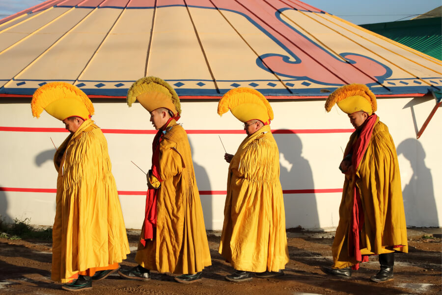 Monks wearing traditional yellow clothes at Gandan monastery