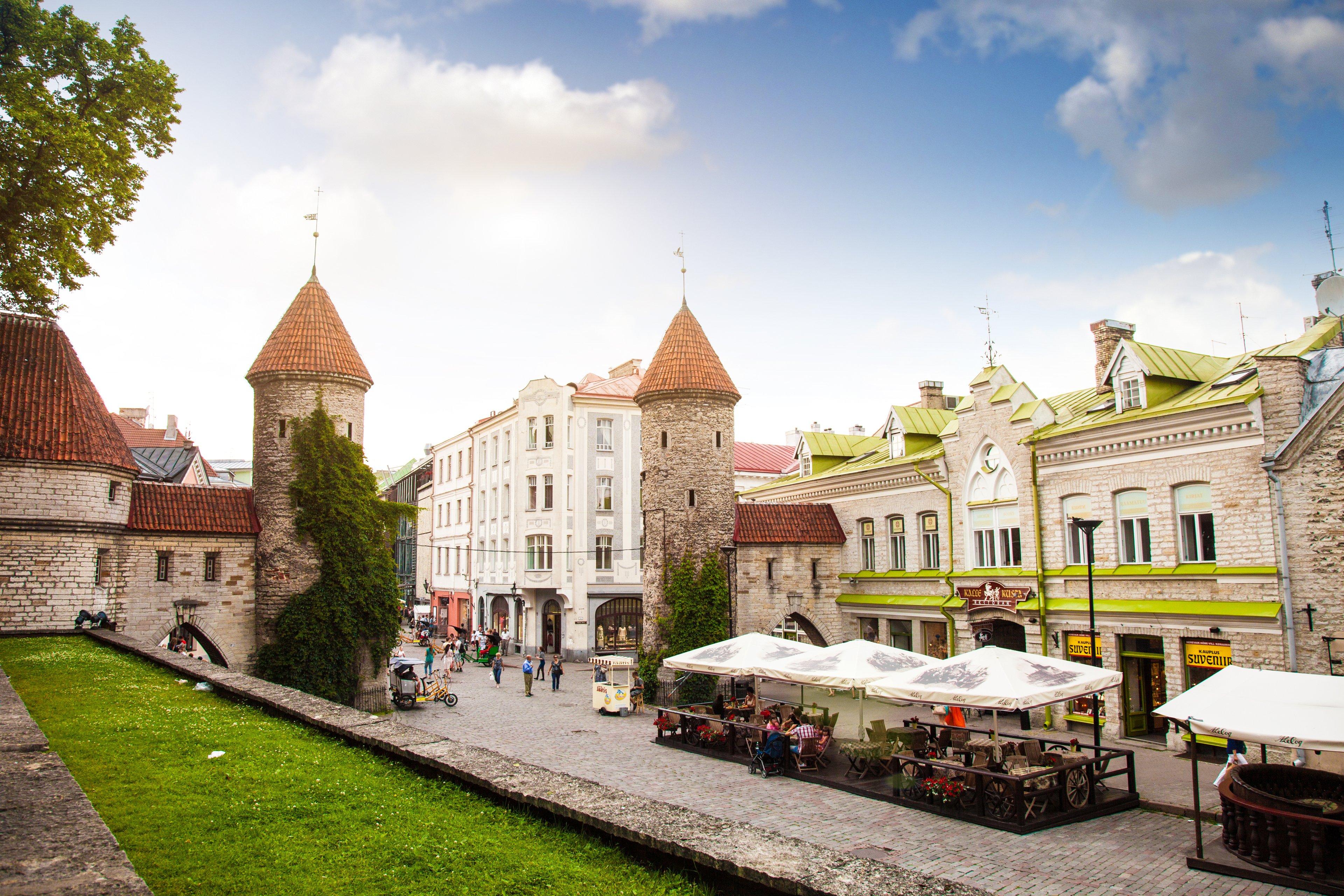 Medieval entrance to Tallinn old town with stone towers and cobbled street, a popular Tallinn sightseeing landmark.