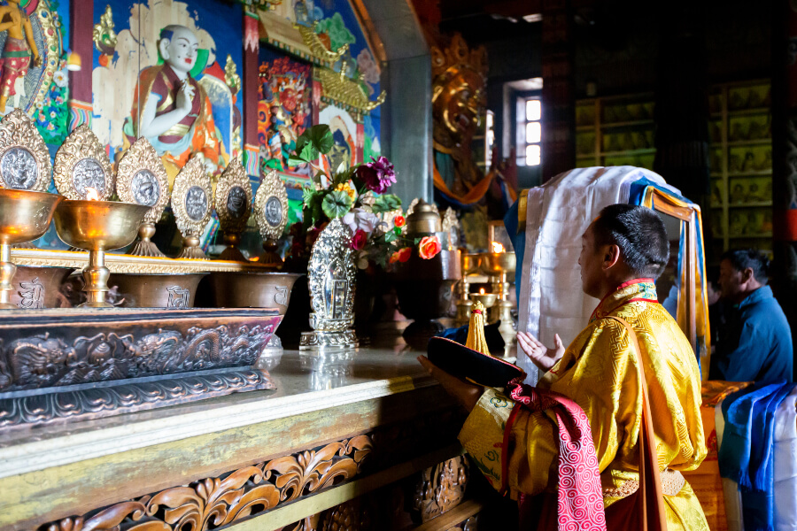 Mongolian buddhist monk praying inside Gandan monastery
