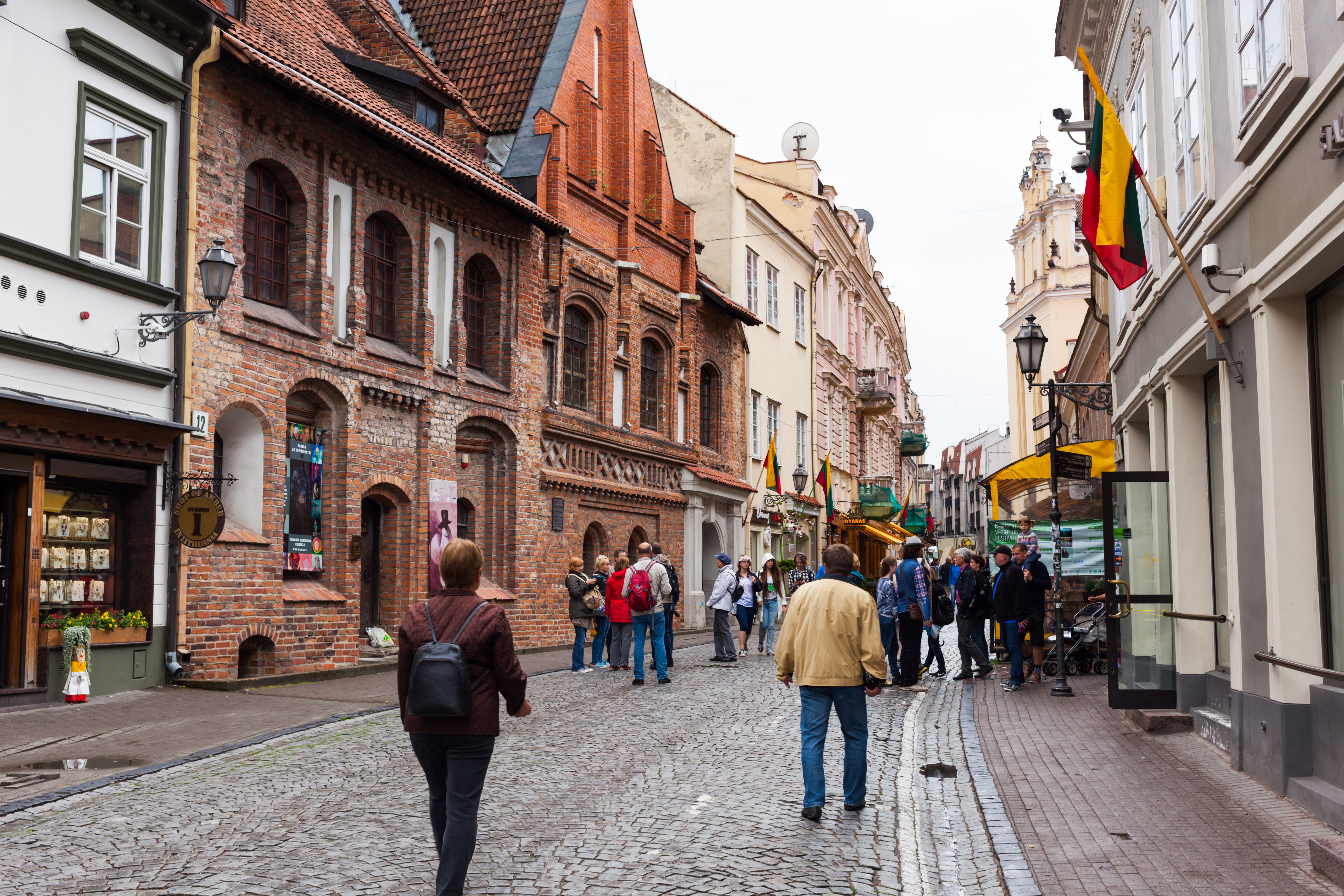 Pilies Street in Vilnius old town with pastel buildings and cobbled pavement, a popular Vilnius travel destination.